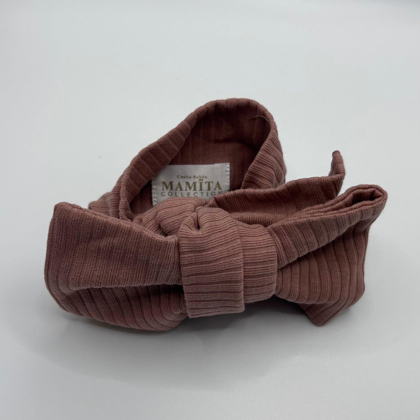 baby rusty pink ribbed knotted headband on a white background