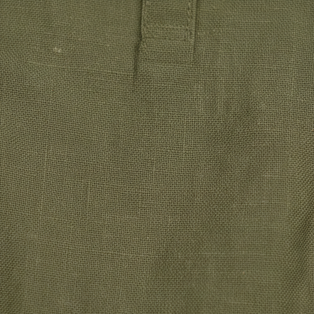 Close-up of olive green Papito Linen Romper organic linen baby romper fabric with textured weave, certified organic baby clothing by casita.