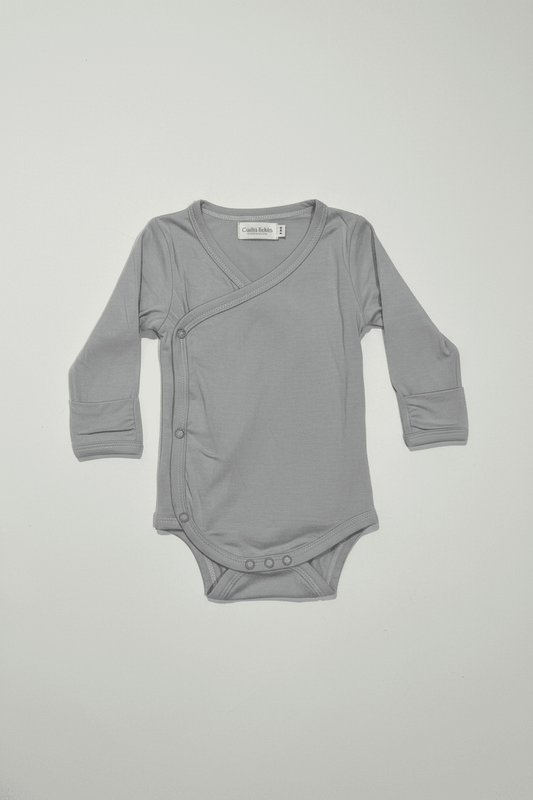Gray baby bodysuit with wrap design on a light gray background