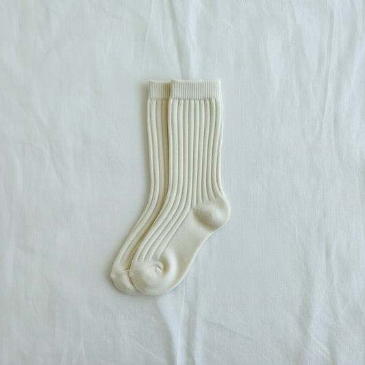 Cream-colored organic cotton ribbed baby socks from Casita Bebes, certified organic baby clothing.