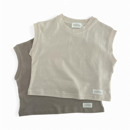 Two sleeveless Papitō Leon shirts in dusty beige and dusty khaki, certified organic baby clothing tags visible.
