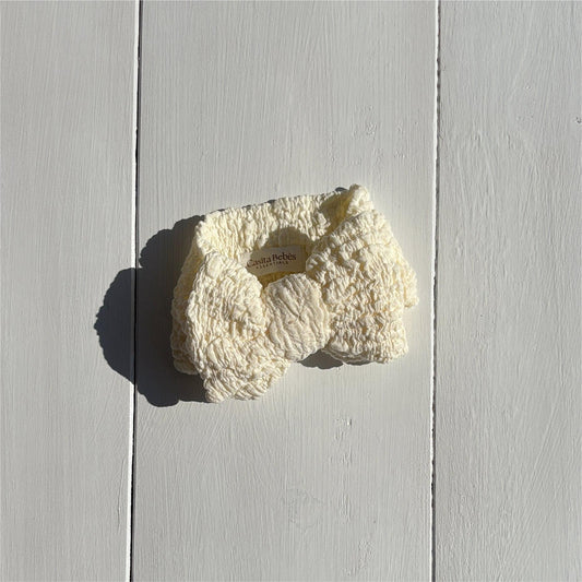 Dusty white organic textured bow for baby clothing by Casita Bebes, certified organic.