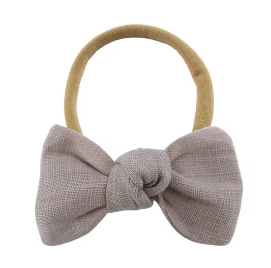 Gray bow hair tie on a white background