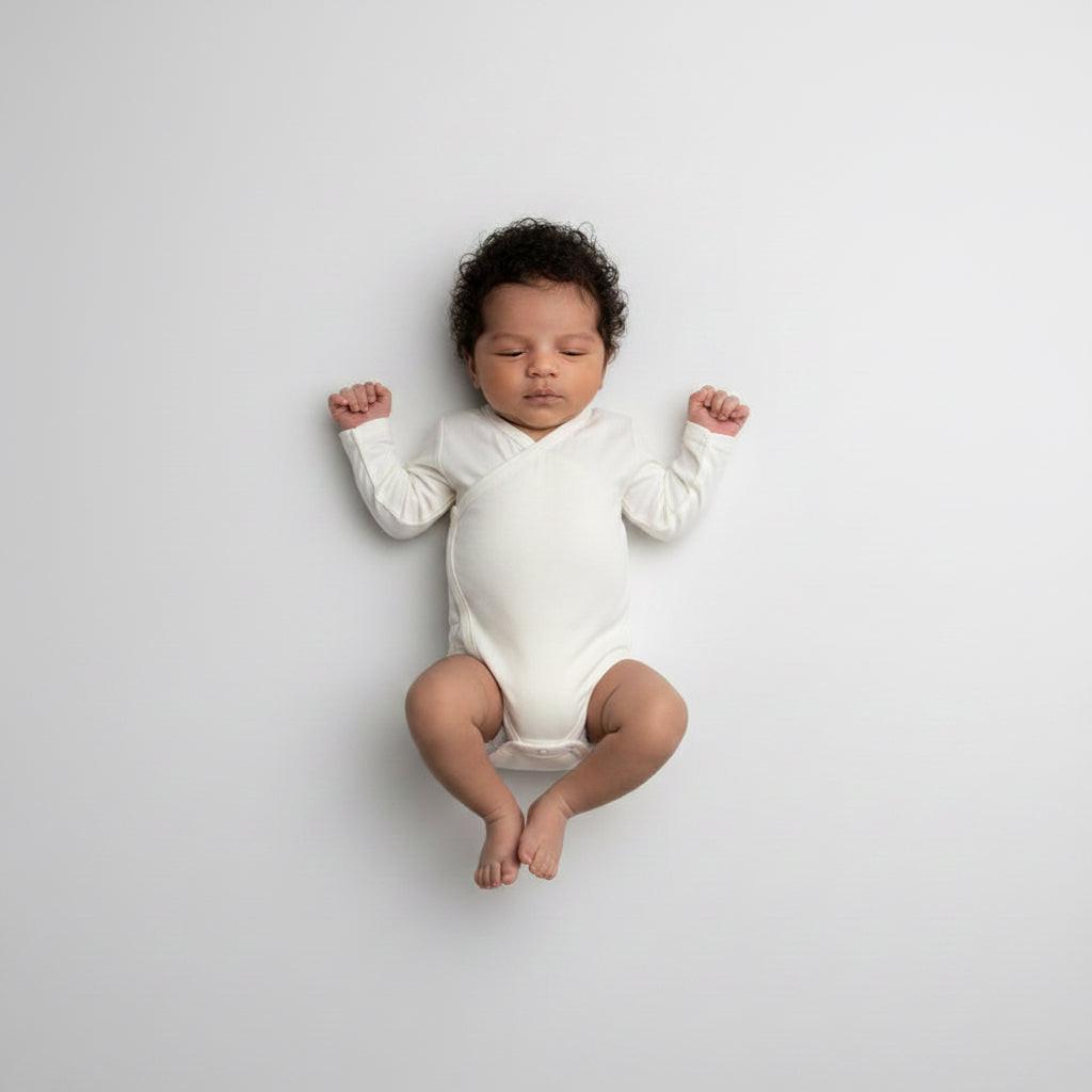 Toddler wearing organic bamboo wrap bodysuit in cream, soft baby clothing by Casita Bebes.