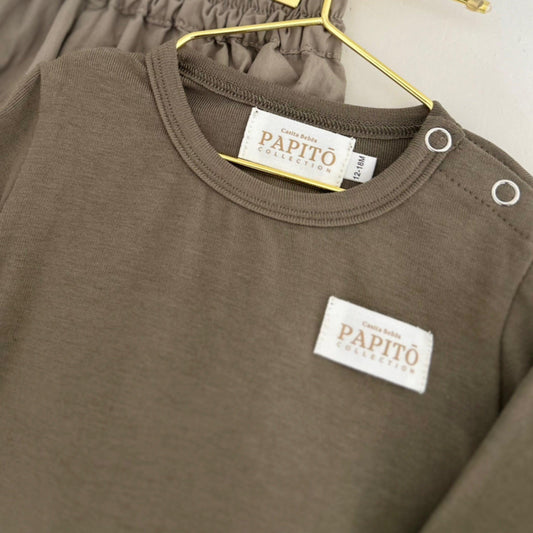 Organic khaki bamboo baby bodysuit with snap buttons and branded patches.