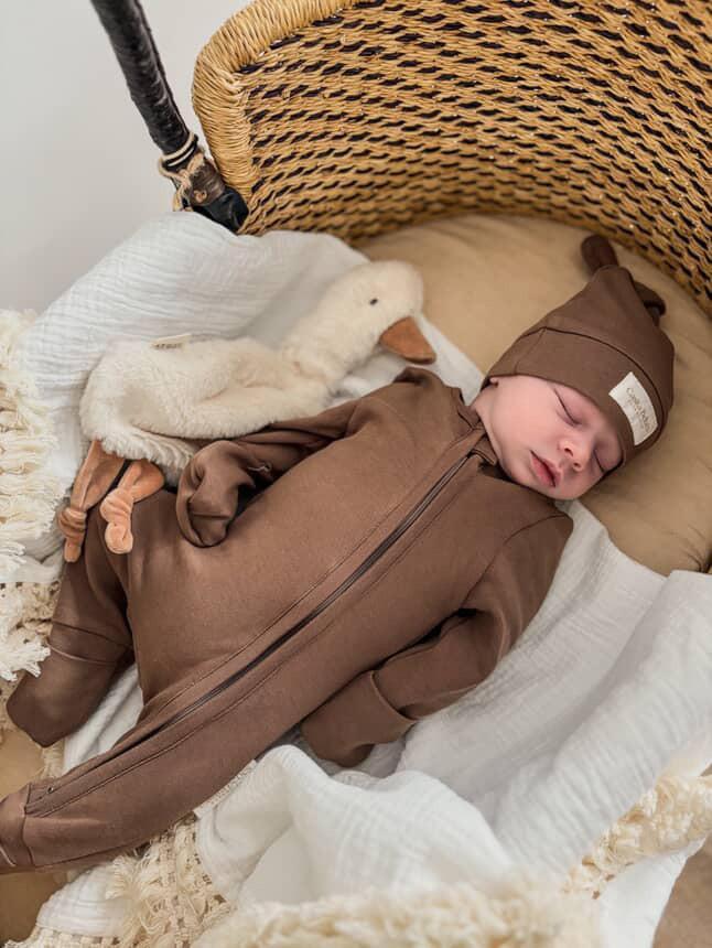 Baby wearing dusty brown organic Essentials knot beanie and matching outfit by Casita Bebes, certified organic.