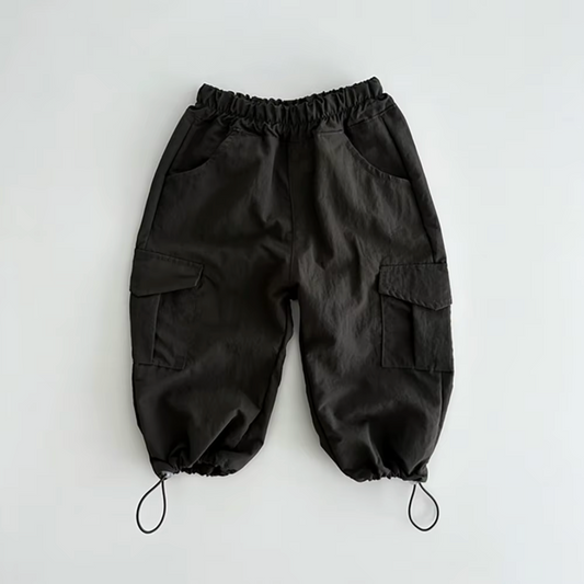 Organic black baby pants with elastic waistband and adjustable drawstring cuffs, certified organic baby clothing by Casita.