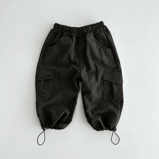 Black organic baby cargo pants with elastic waist and adjustable cuffs, perfect for everyday wear.