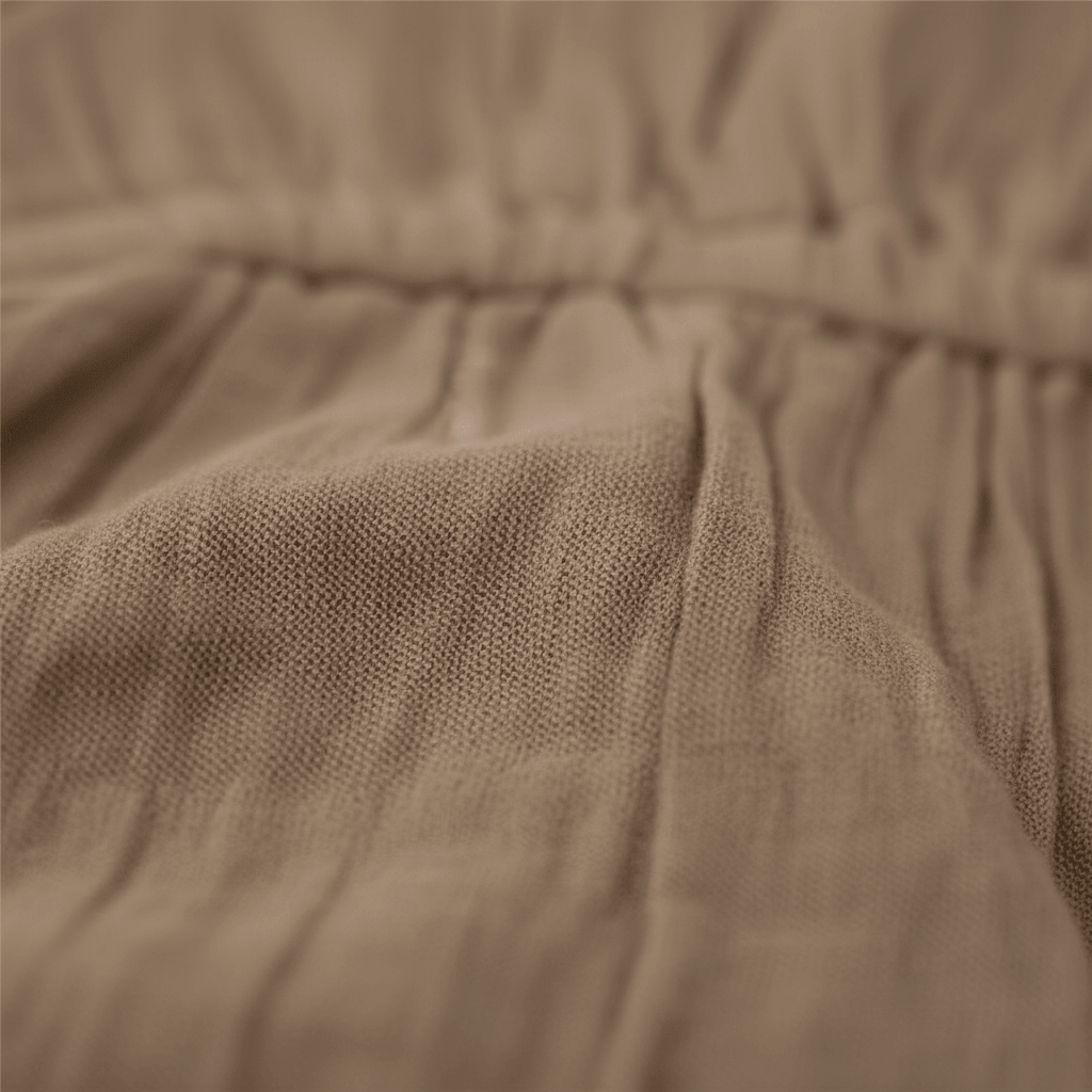 Soft organic cotton baby clothing with gentle pleats and cozy texture