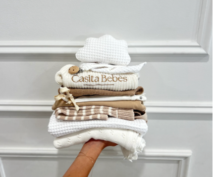 A stack of organic baby clothing perfect for baby shower gift