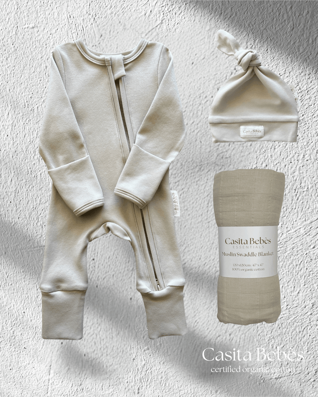Organic cotton baby onesie, swaddle blanket, and hat set for newborns