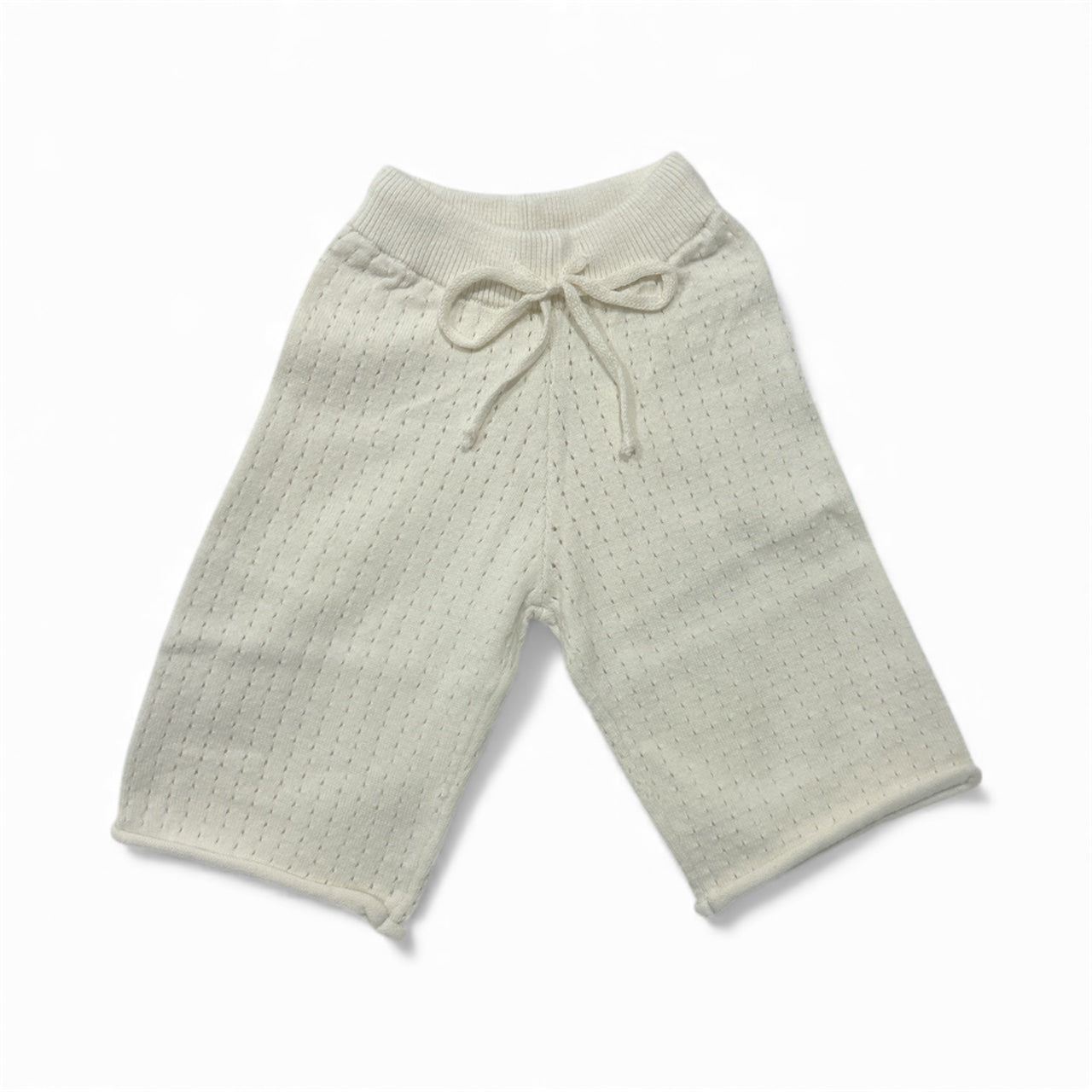 close up Light cream knitted breathable baby pants with a drawstring on a white background brand Casita Bebes