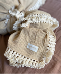 Neutral Beige baby blanket with tassels details on a brown surface with Casita Bebes brand