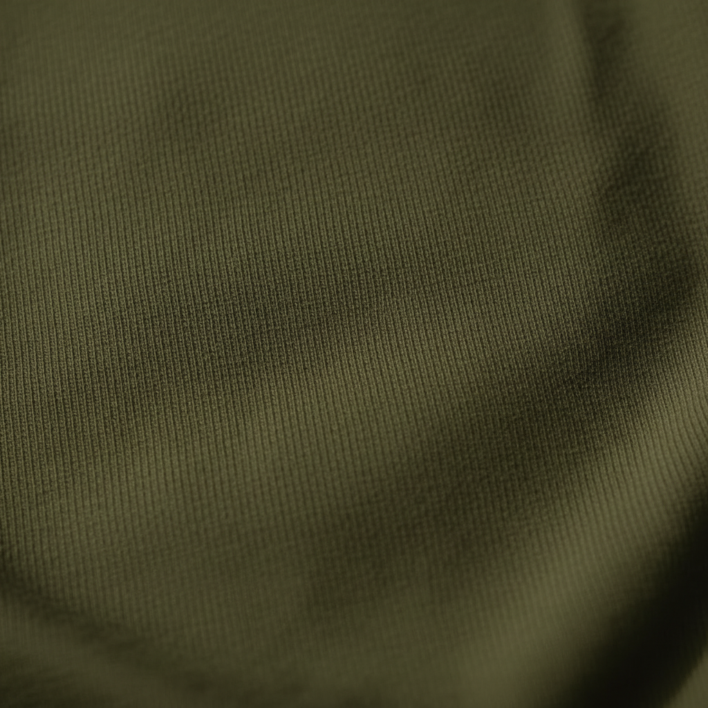Close-up of olive green certified organic baby clothing fabric from Casita Bebes Papitō Mercutio Romper.