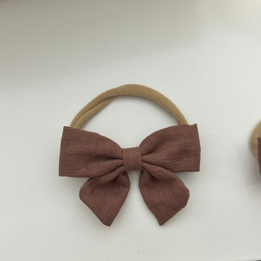 Dusty Pink bow hair tie newborn/toddler on a white background