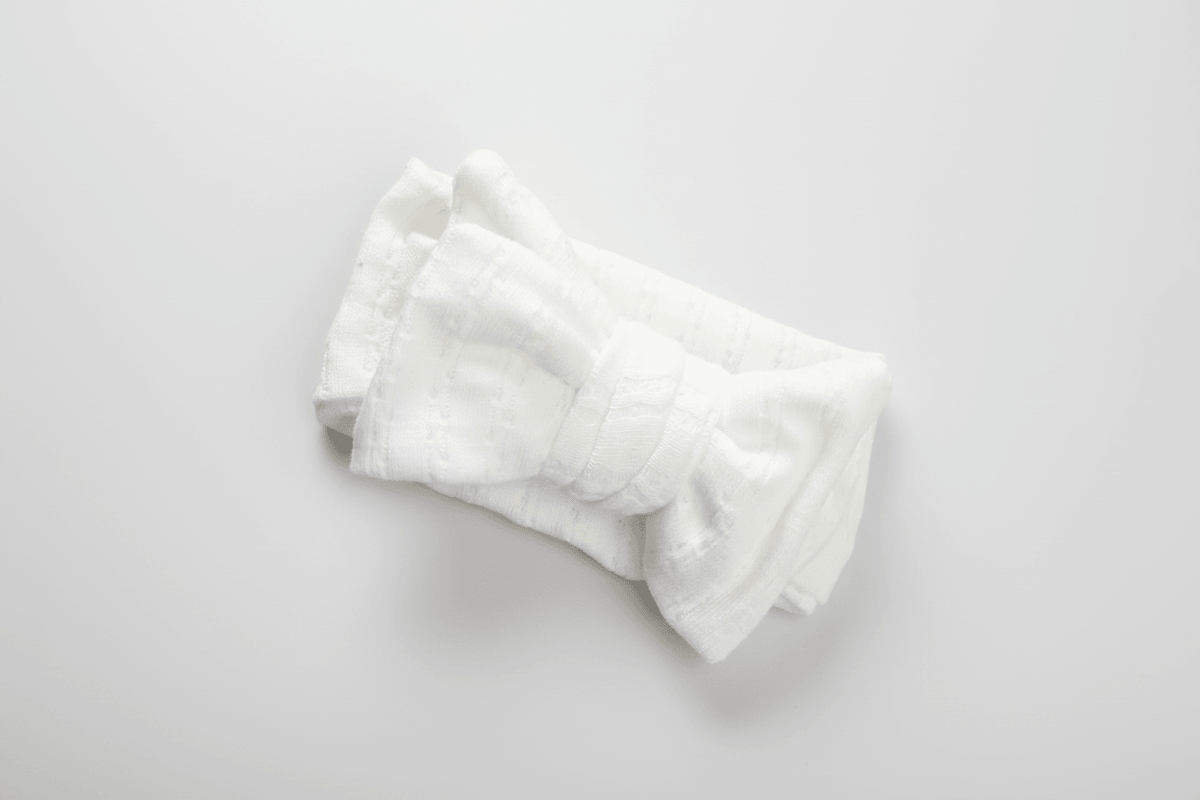 Soft white organic baby blanket with textured weave, perfect for newborns and gentle everyday use.
