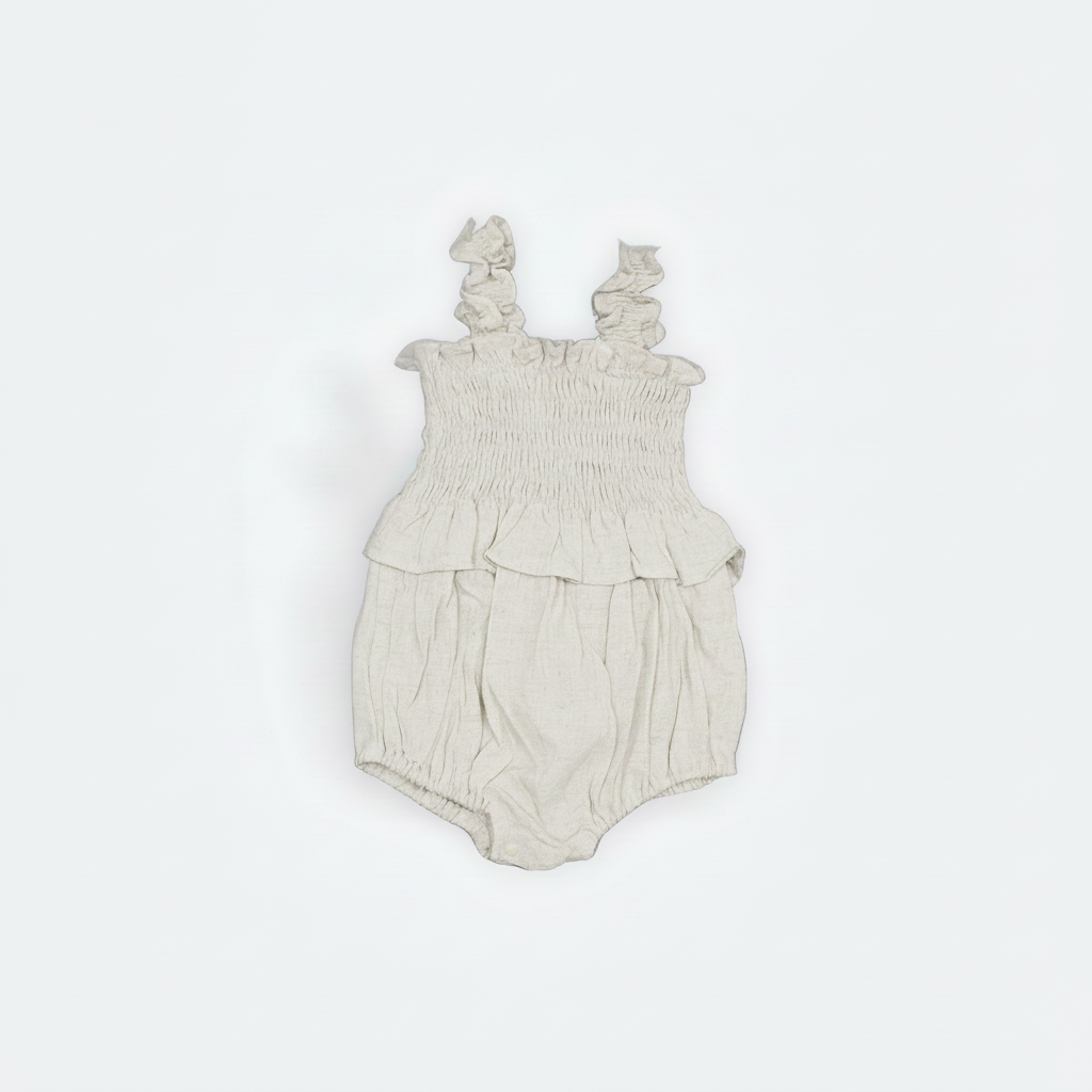 Beige baby romper with ruffled straps on a white background Flat Layed
