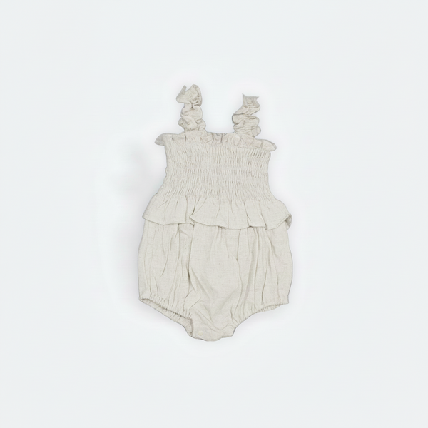 Beige baby romper with ruffled straps on a white background Flat Layed