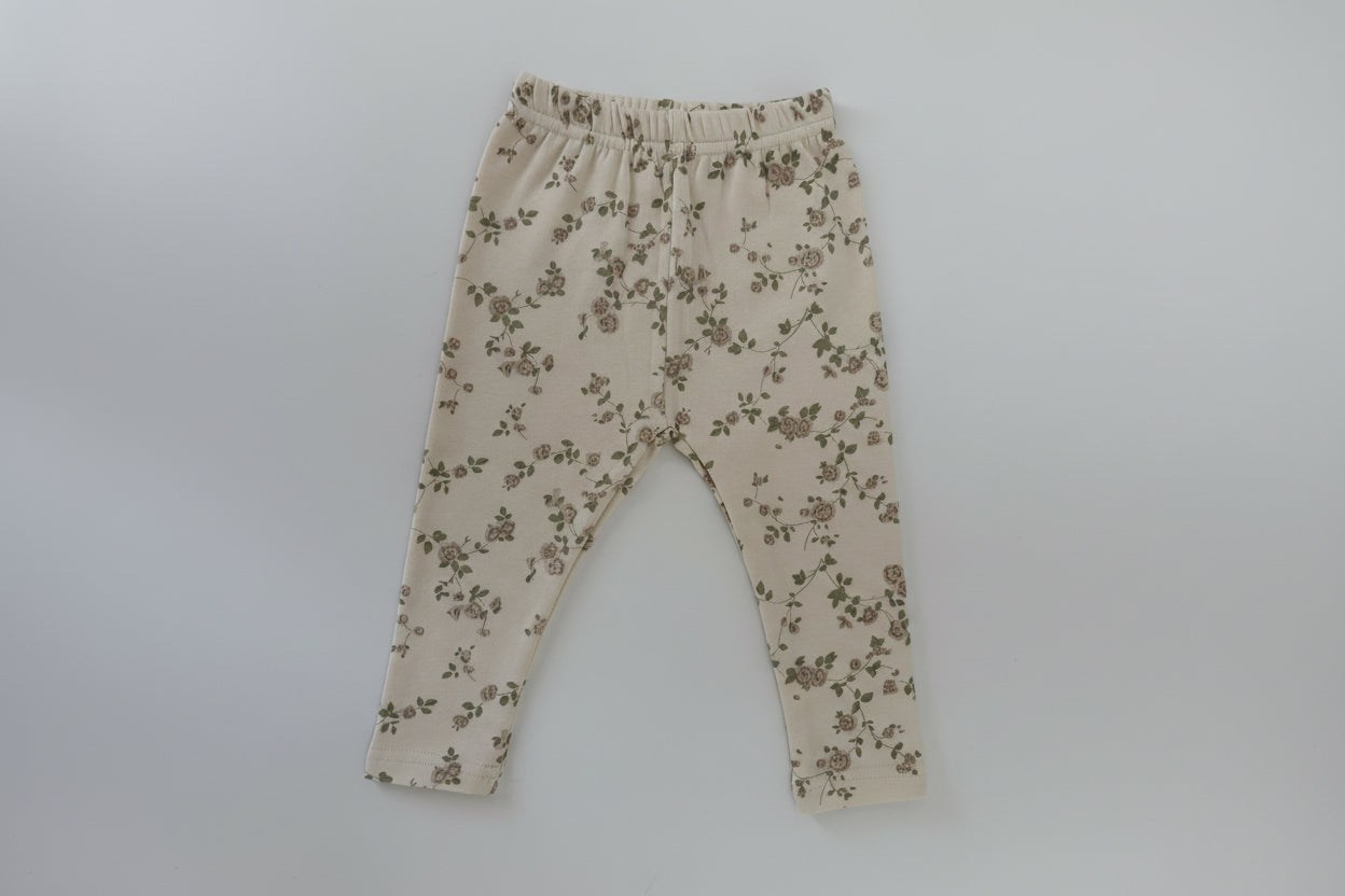 Beige pants with floral pattern on a white background