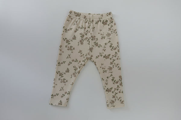 Beige pants with floral pattern on a white background