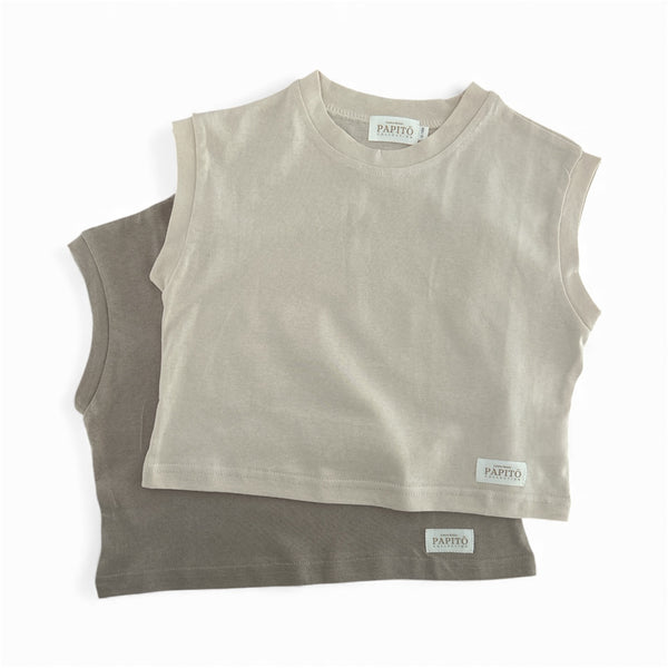 Two beige sleeveless shirts stacked on a white background with 'Papito’ boy branding from casita Bebes 