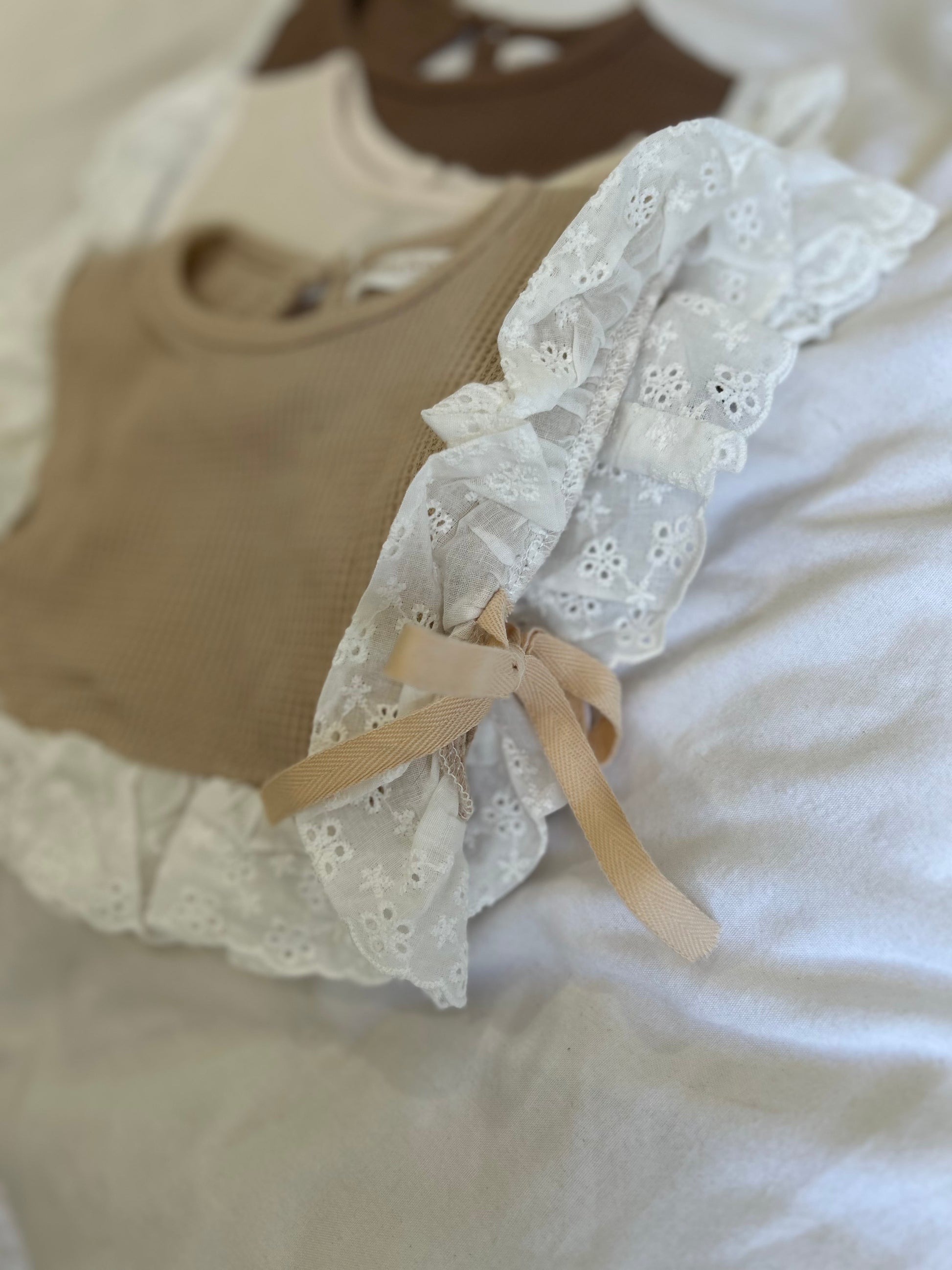 Side view of baby lace bib with side bow