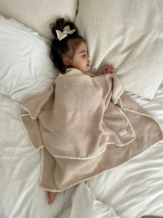 Toddler sleeping with Organic essentials bubble knitted  dusty brown  baby blanket from Casita Bebes, soft certified organic fabric on newborn baby wearing neutral.
