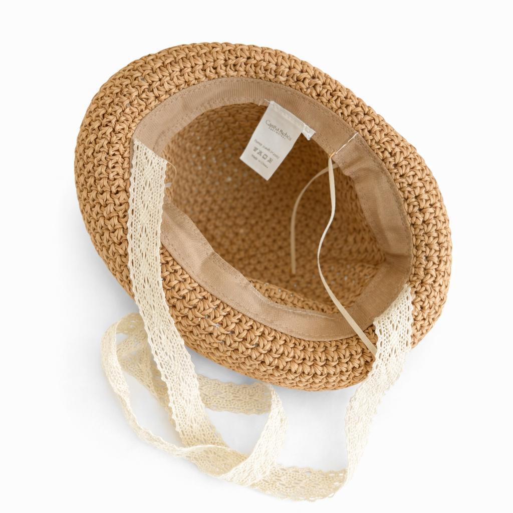 Organic baby straw hat with lace ribbon, perfect for gentle summer days