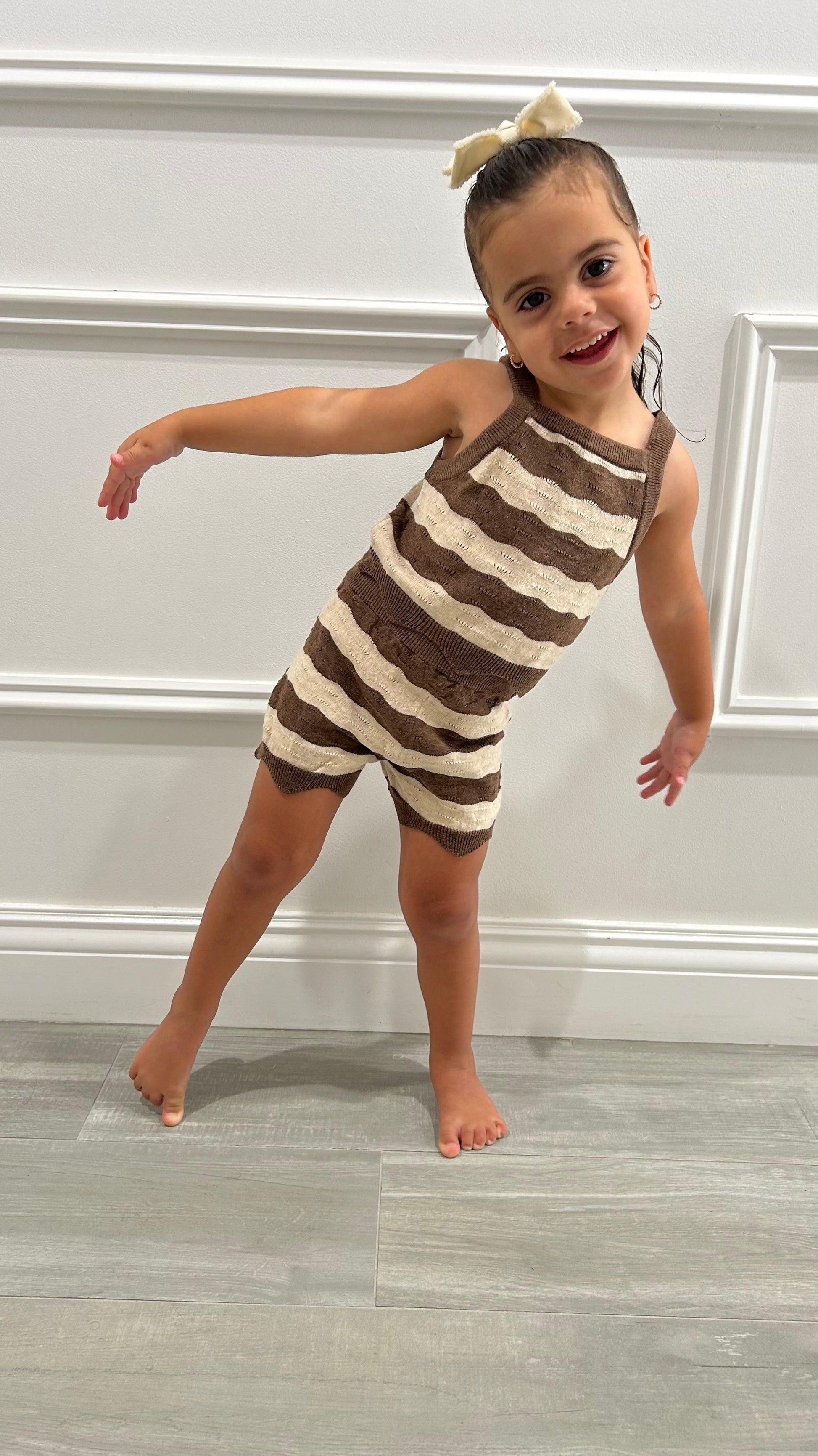 Baby wearing striped organic cotton swim top and shorts set by Casita Bebes, certified organic baby clothing.