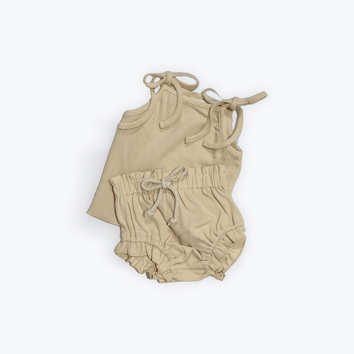 Organic baby romper with ruffled shorts and tie straps, soft beige corduroy