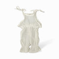 Organic cotton baby romper with tie straps and ruffled hem, soft neutral tone for newborns