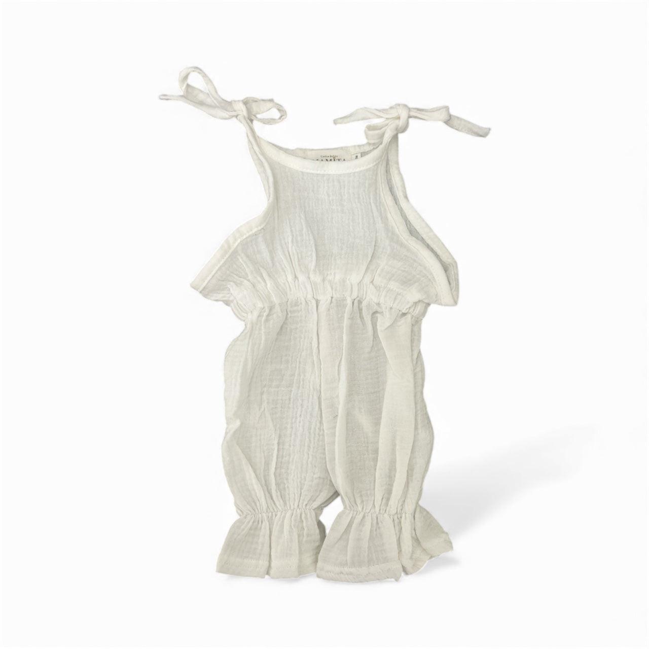 White organic cotton baby jumpsuit with tie straps and ruffled hems, certified organic baby clothing.