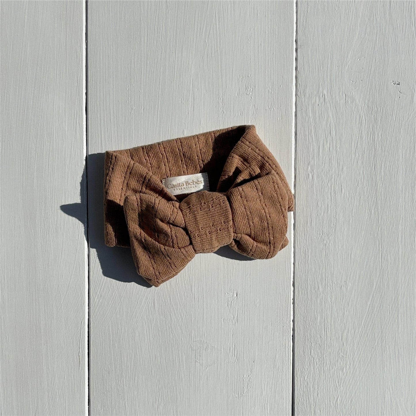 Dusty brown organic linen bow headband from Essentials Collection, certified organic baby accessory.