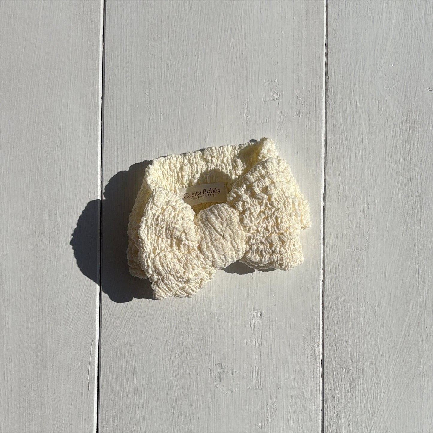 Dusty white organic textured bow for baby clothing by Casita Bebes, certified organic.