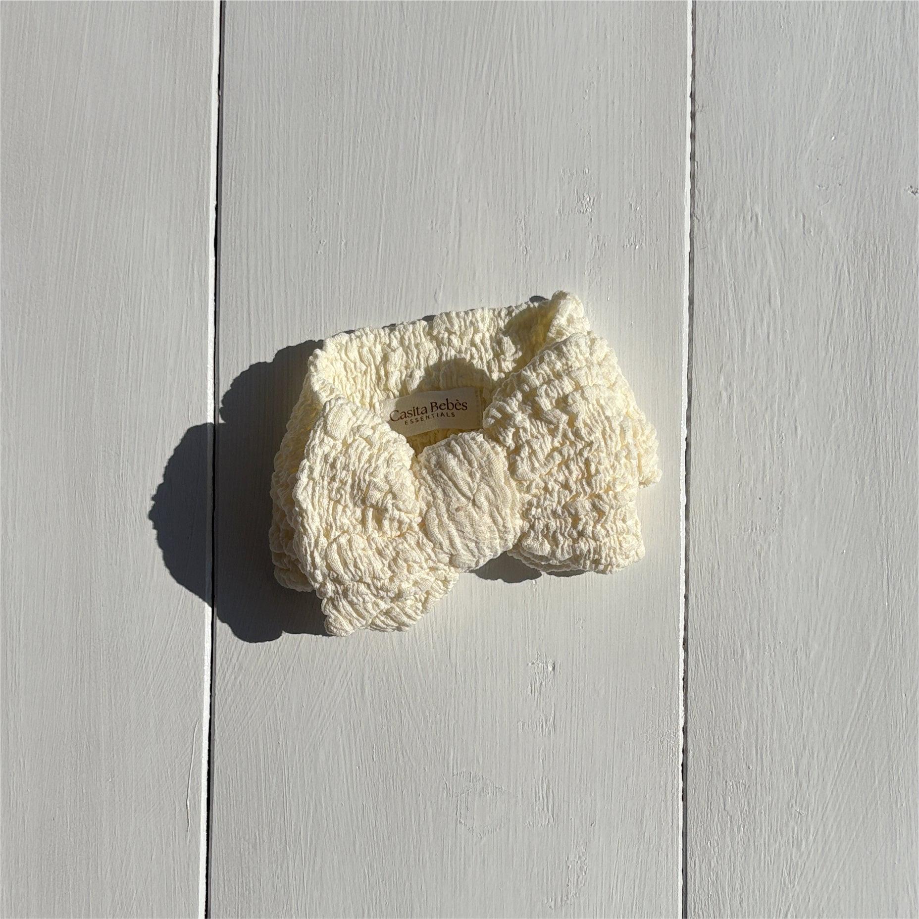 Dusty white organic textured bow for baby clothing by Casita Bebes, certified organic.