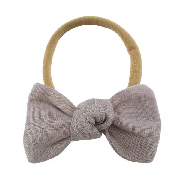 Gray bow hair tie on a white background