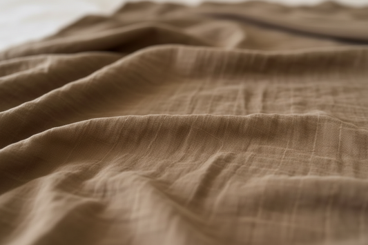 Close-up of dusty brown muslin swaddle made from certified organic cotton by Casita Bebes.