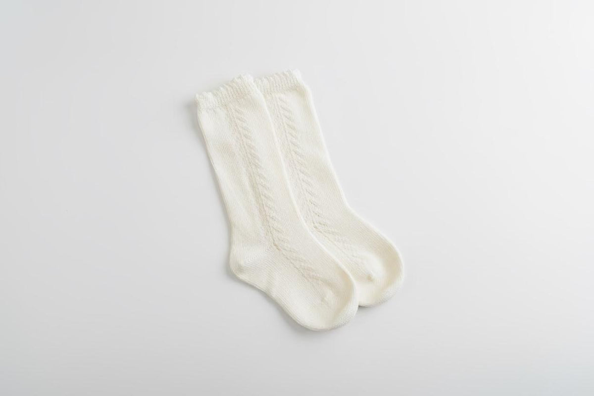 Soft organic baby socks with cable knit design, perfect for newborns and infants