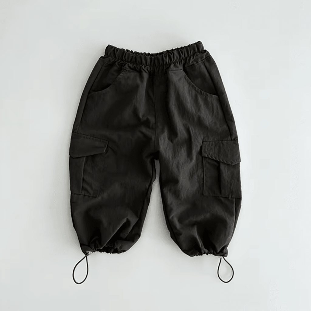 Black organic baby cargo pants with elastic waist and adjustable cuffs, perfect for everyday wear.