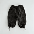 Black organic baby cargo pants with elastic waist and adjustable cuffs, perfect for everyday wear.