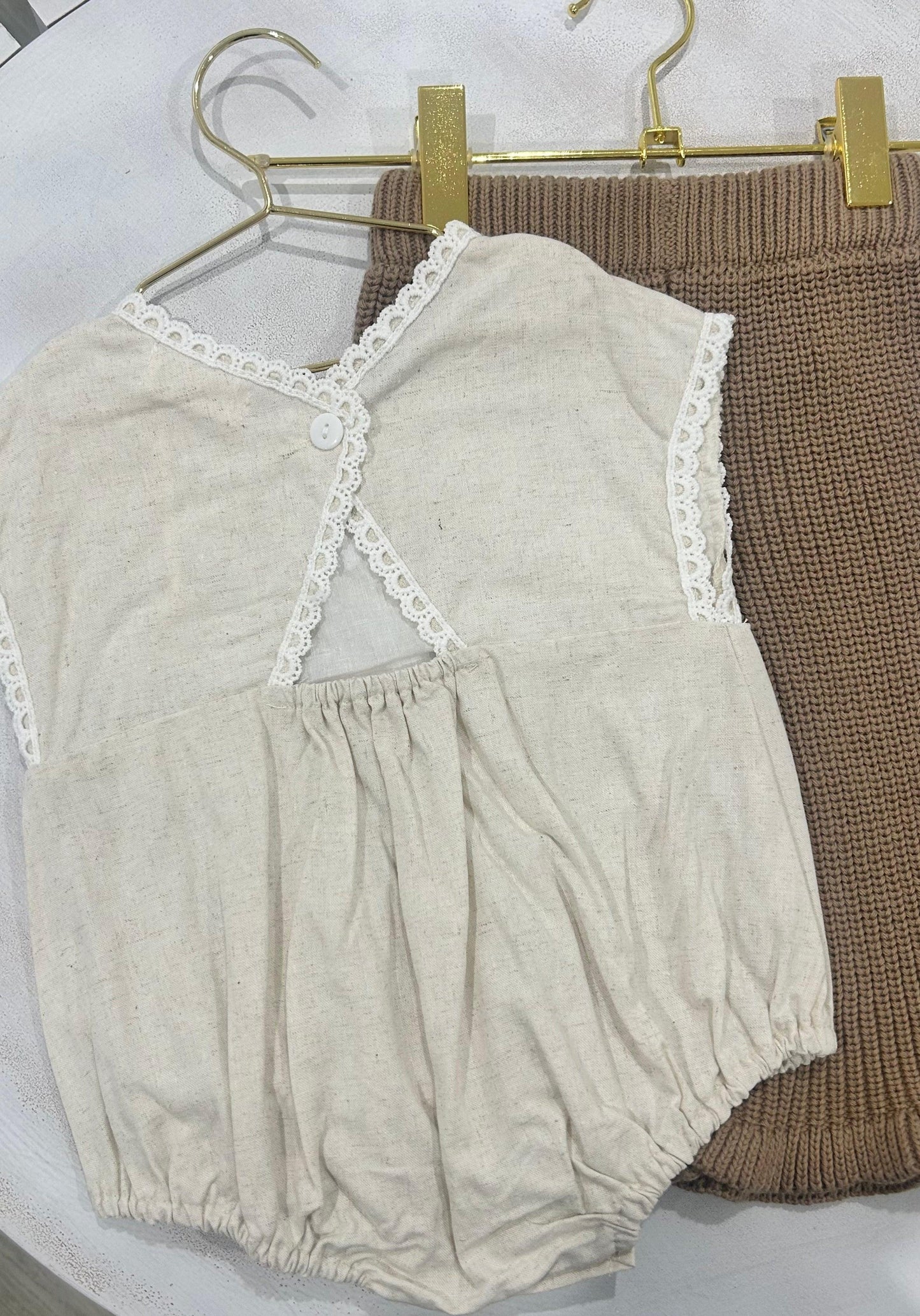 Organic cotton baby girl romper in beige with lace trim from Casita Bebes, certified organic.