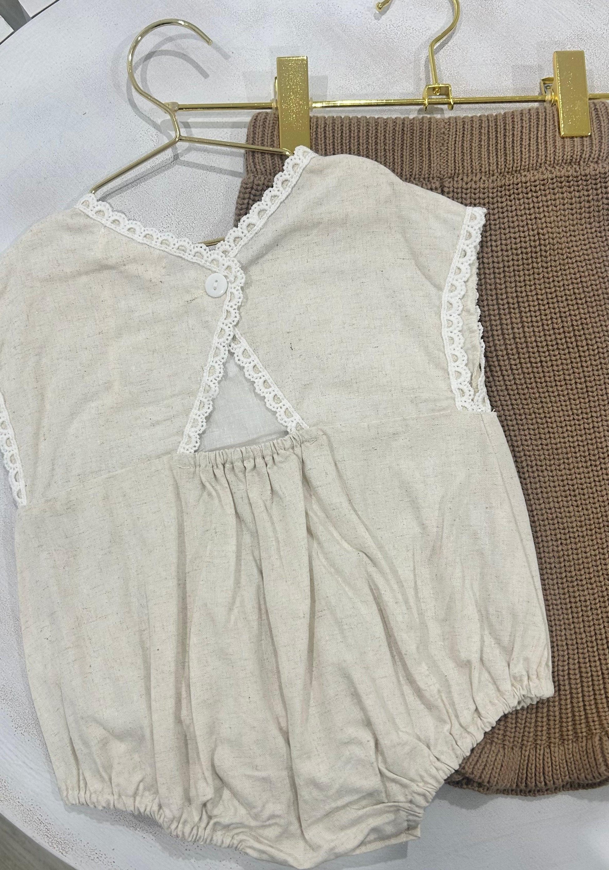 Organic cotton baby girl romper in beige with lace trim from Casita Bebes, certified organic.