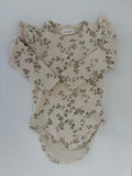 Organic baby onesie with floral print and lace ruffle sleeves, soft and gentle for newborns