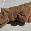 Soft brown organic baby headband with knotted bow, ribbed texture, gentle newborn accessory