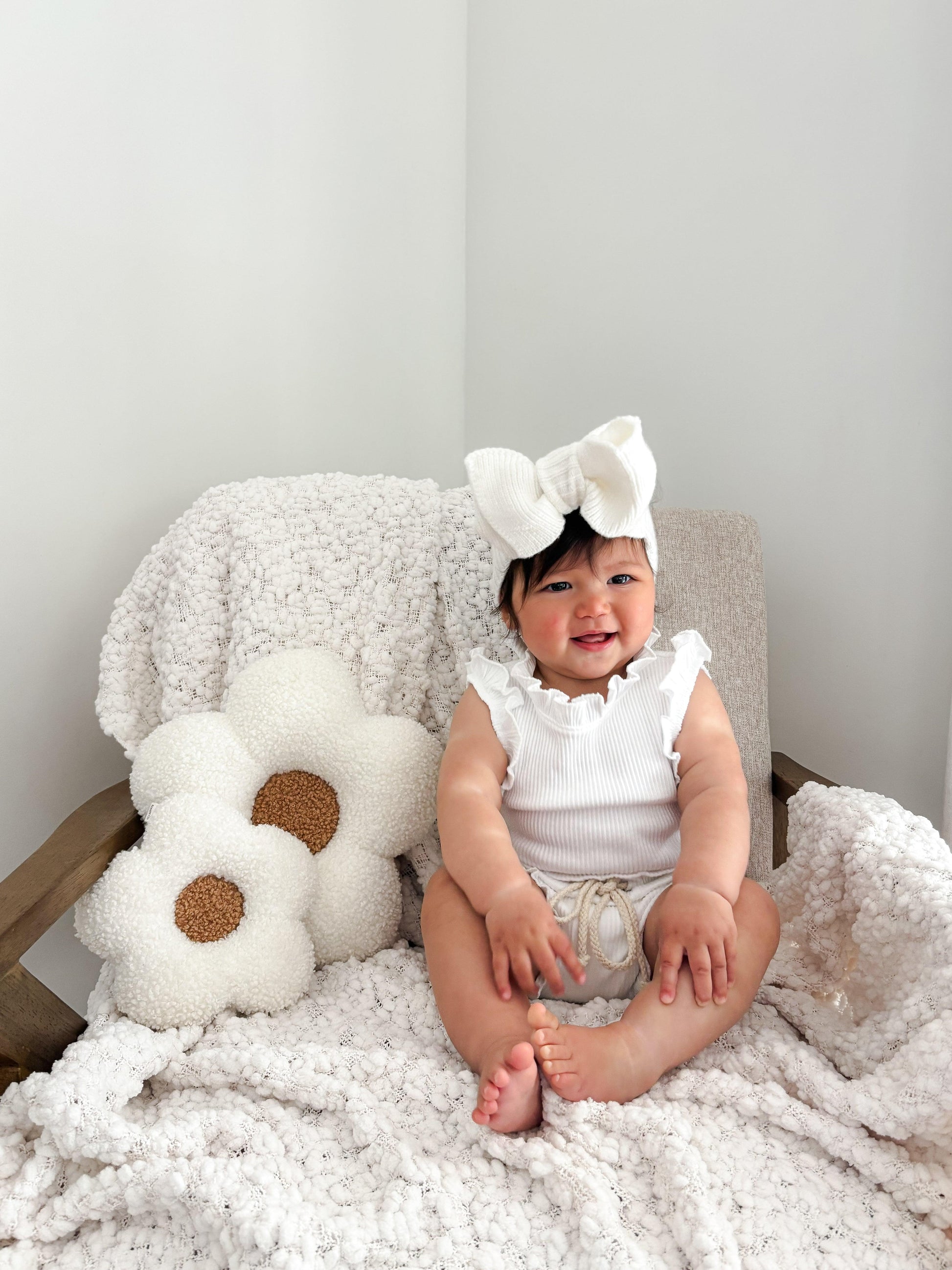Organic white cotton baby bodysuit with ruffle sleeves on smiling baby, casita bebes style.