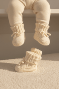 Soft organic baby booties with ribbed cuffs and bows, perfect for newborns and infants