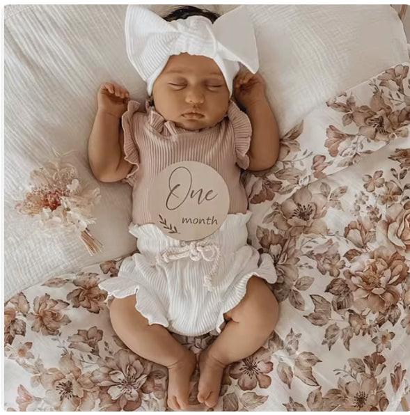 Organic baby clothing bloomer in white on sleeping baby with headband, certified organic by Casita Bebes.