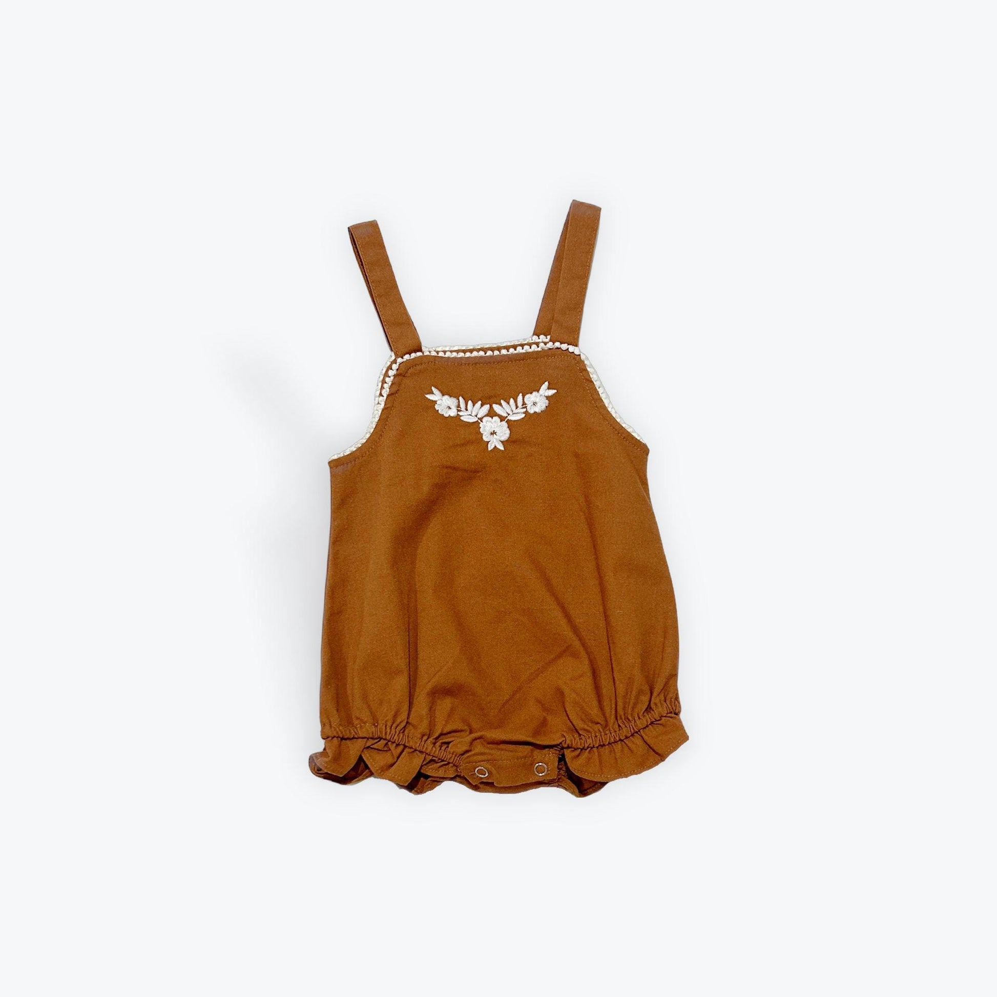 Organic cotton baby romper in warm brown with embroidered floral detail and ruffled hem from Casita Bebes.